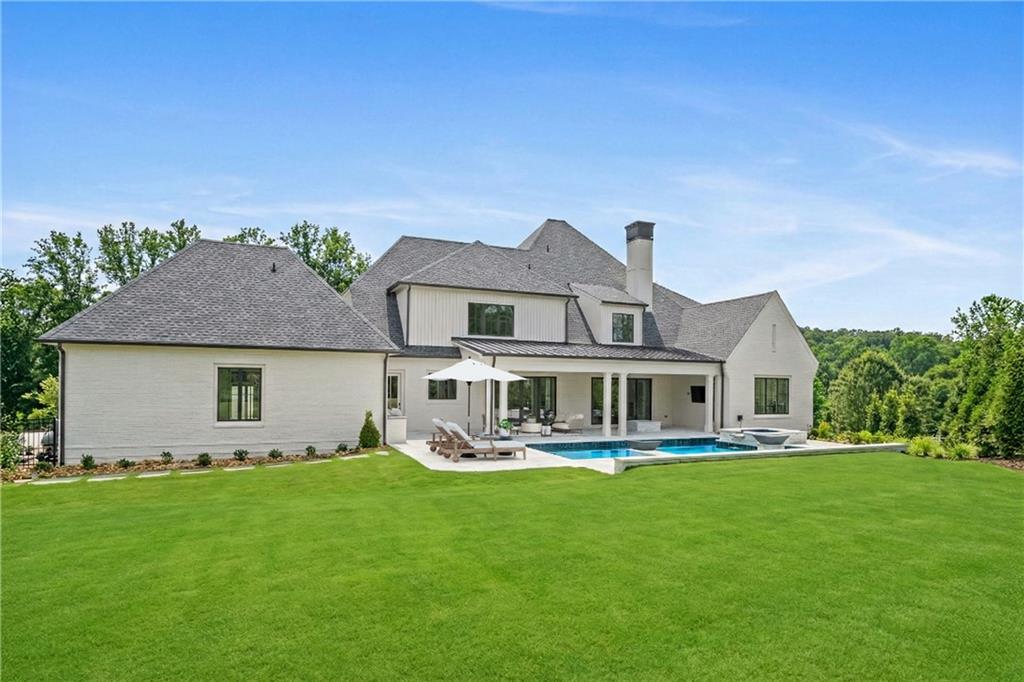10210 Cedar Ridge Drive Milton, GA 30004 - Photo 22 of 24 a front view of a house with a yard table and chairs