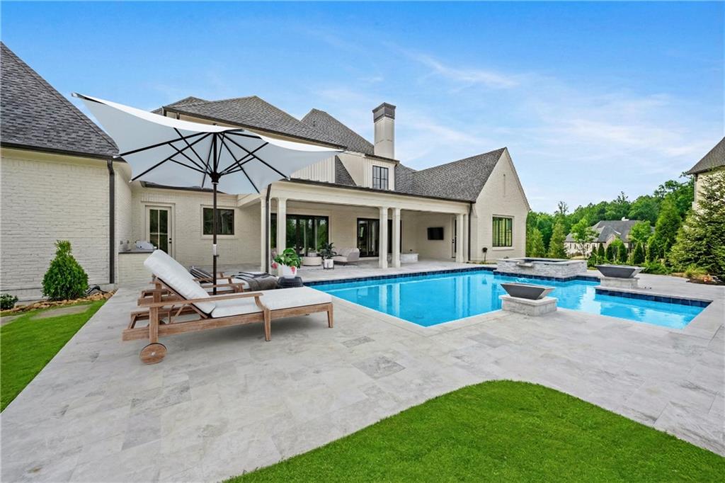 10210 Cedar Ridge Drive Milton, GA 30004 - Photo 23 of 24 a view of house with swimming pool outdoor seating and house in the background