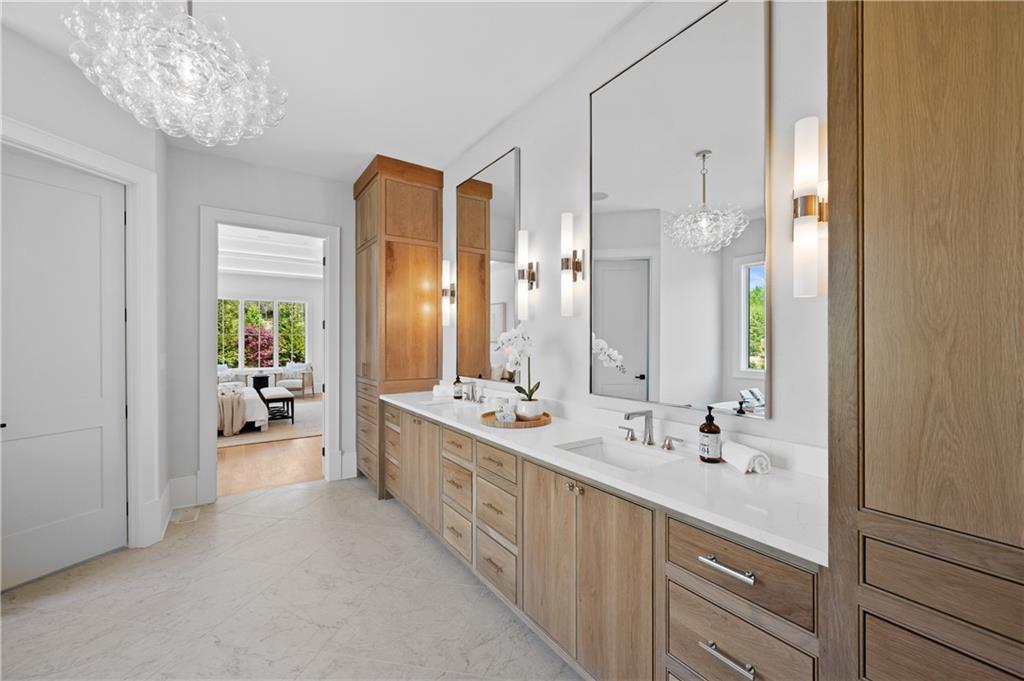 10210 Cedar Ridge Drive Milton, GA 30004 - Photo 29 of 47 a bathroom with a double vanity sink and a large mirror