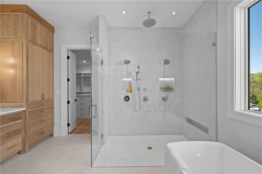 10210 Cedar Ridge Drive Milton, GA 30004 - Photo 30 of 47 a bathroom with a bathtub and a shower