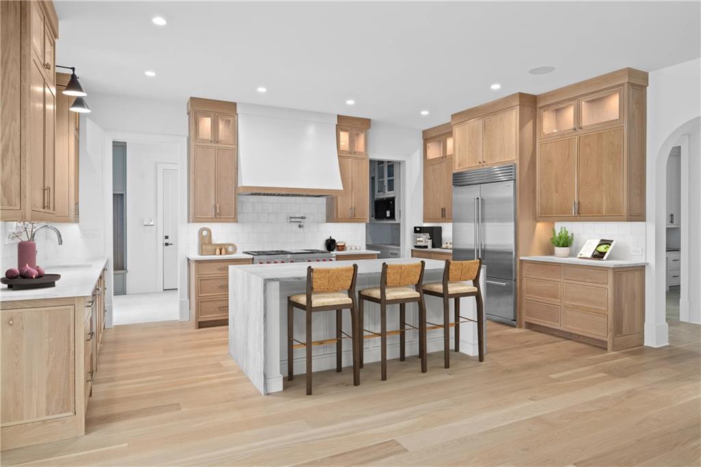 10210 Cedar Ridge Drive Milton, GA 30004 - Photo 3 of 24 a large kitchen with kitchen island a large counter space a sink appliances and cabinets