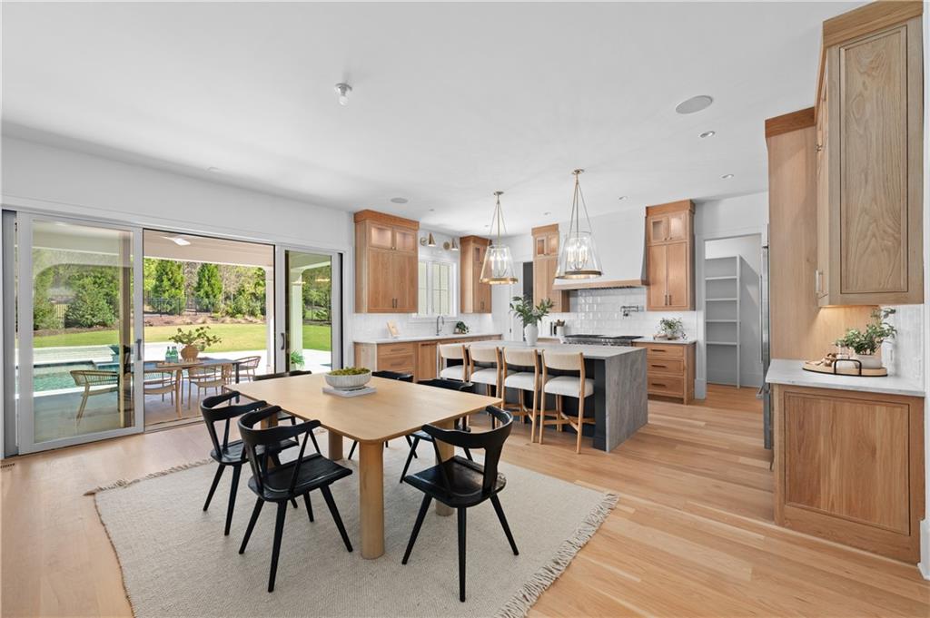 10210 Cedar Ridge Drive Milton, GA 30004 - Photo 4 of 47 a view of a dining room with furniture and wooden floor