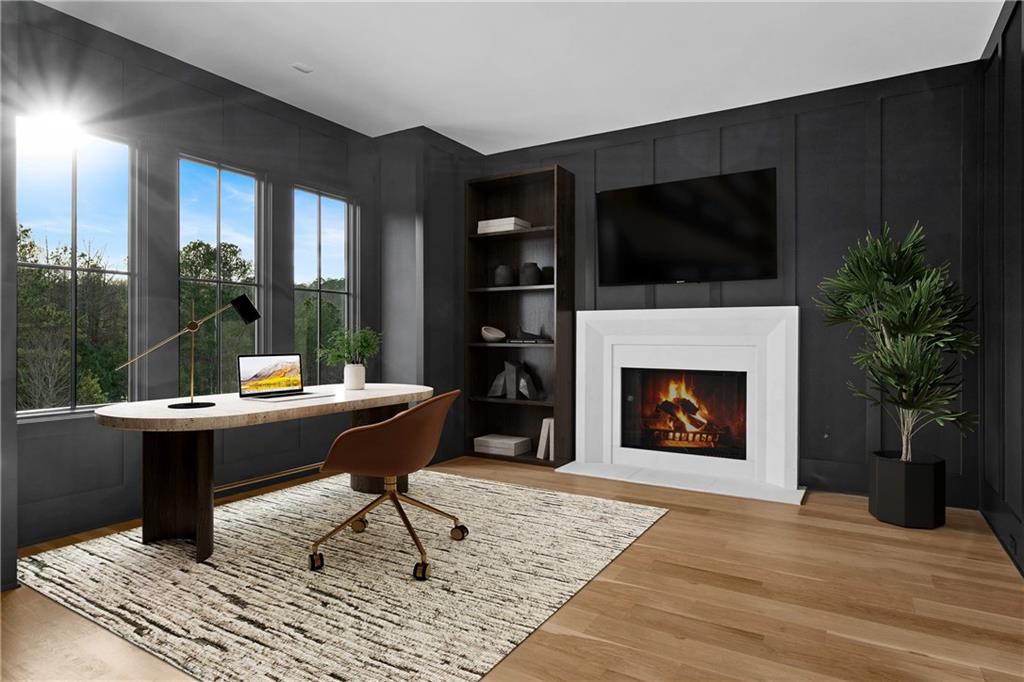 10210 Cedar Ridge Drive Milton, GA 30004 - Photo 5 of 24 a living room with furniture a flat screen tv and a fireplace