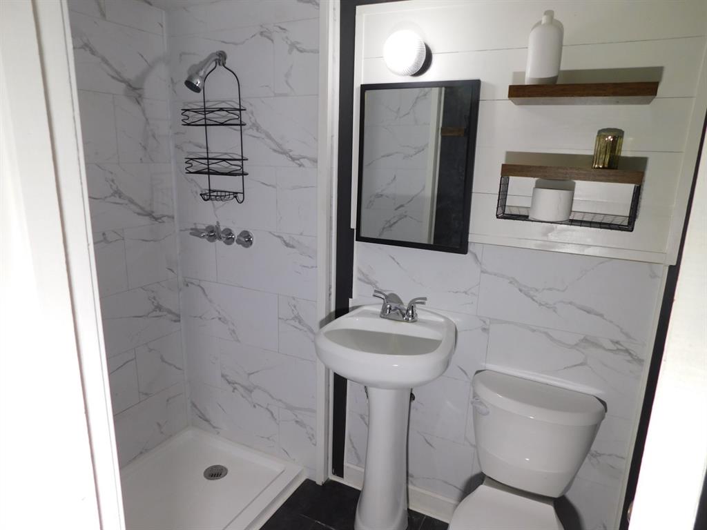 300 South Main Street Springhill, LA 71075 - Photo 30 of 35 a bathroom with a sink a toilet and shower