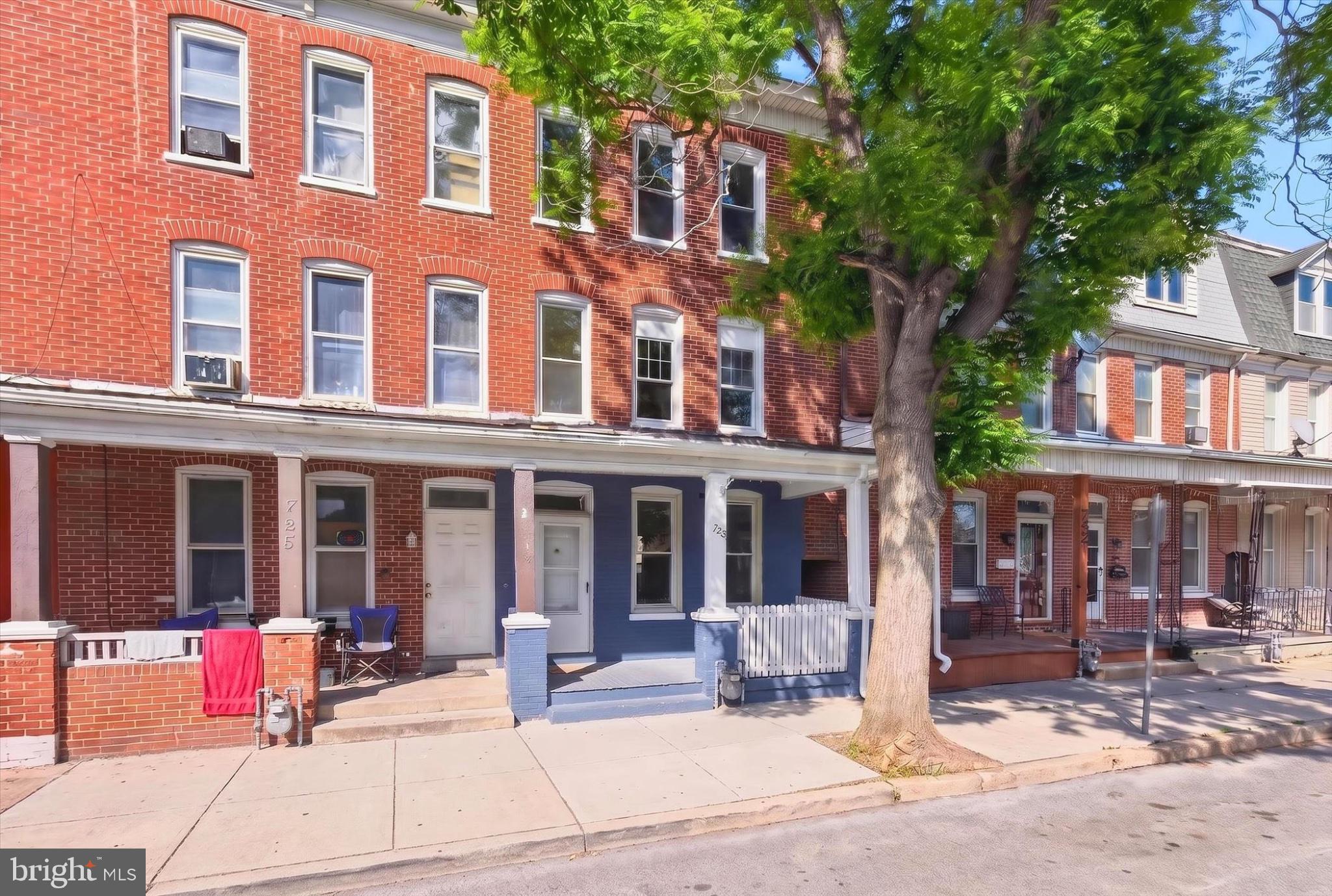 Charming brick facade with inviting porch.