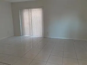 a kitchen with a refrigerator sink and cabinets