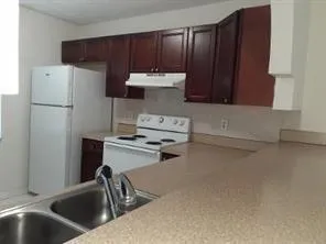 a white refrigerator freezer sitting inside of a kitchen
