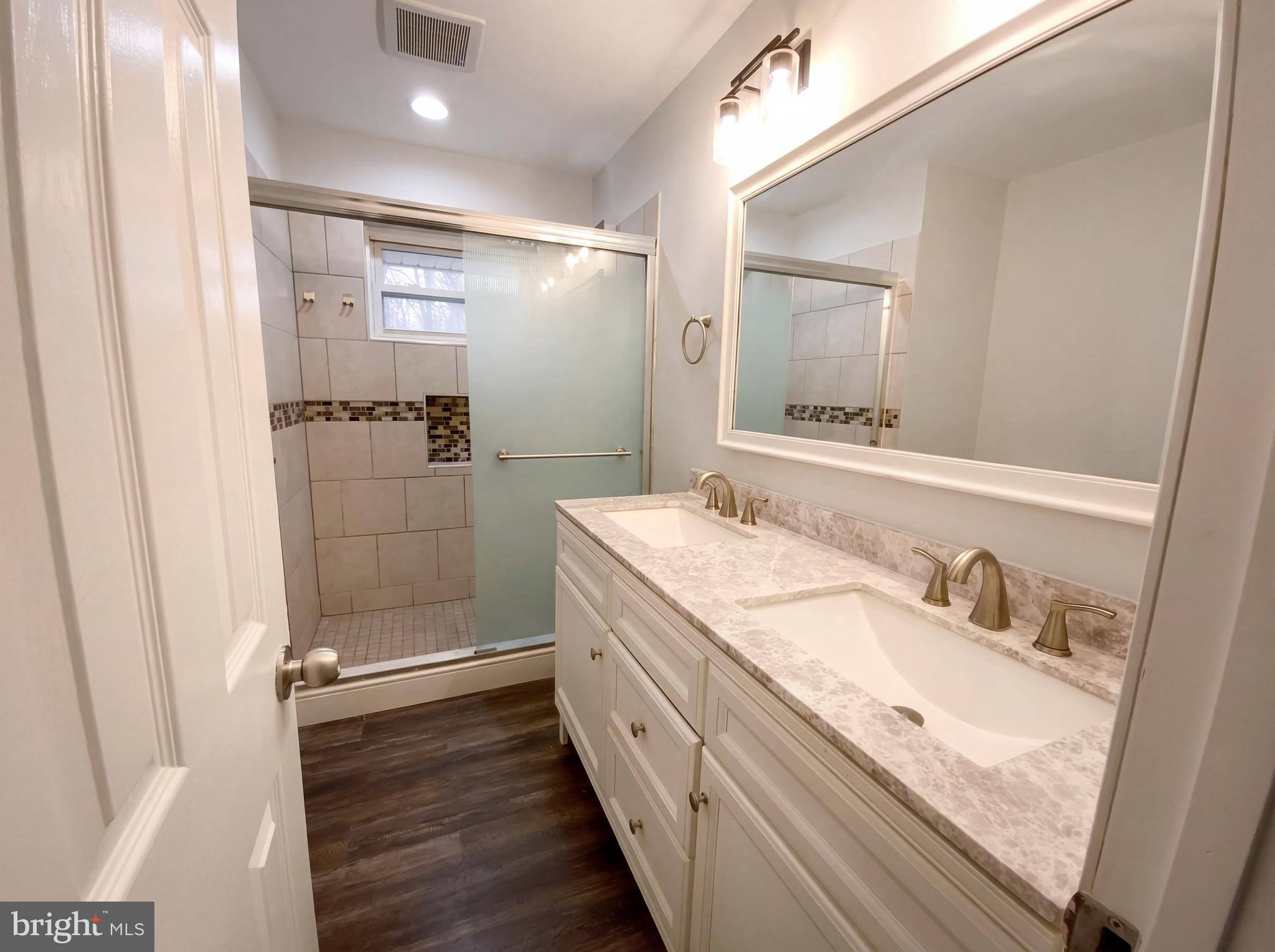 18320 Candice Drive Triangle, VA 22172 - Photo 6 of 19 a bathroom with a granite countertop sink mirror and shower