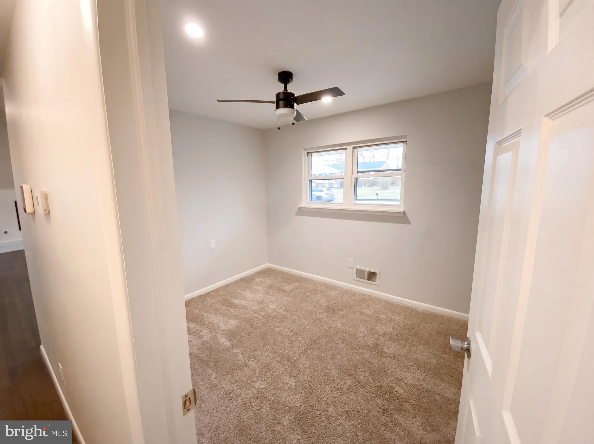 18320 Candice Drive Triangle, VA 22172 - Photo 8 of 19 an empty room with a window and a fan