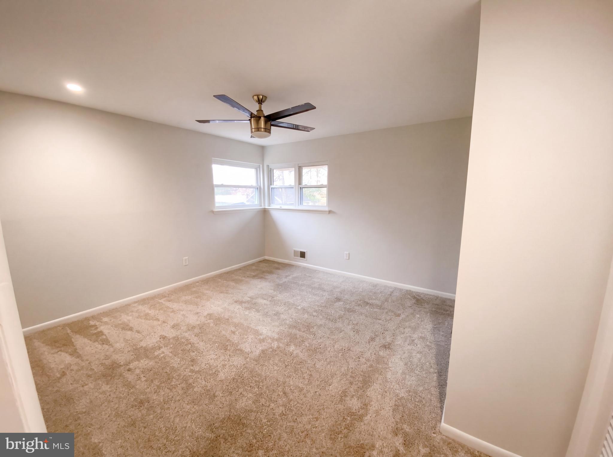 18320 Candice Drive Triangle, VA 22172 - Photo 9 of 19 en empty room with windows and ceiling fan