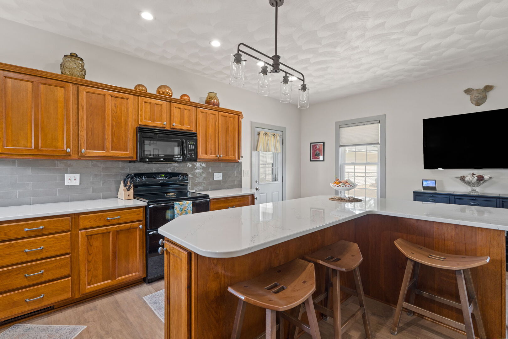 417 North State Street Geneseo, IL 61254 - Photo 8 of 51 a kitchen with stainless steel appliances a stove a sink a microwave a dining table and chairs with wooden floor