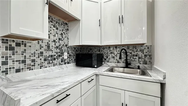 a kitchen with a sink and cabinets
