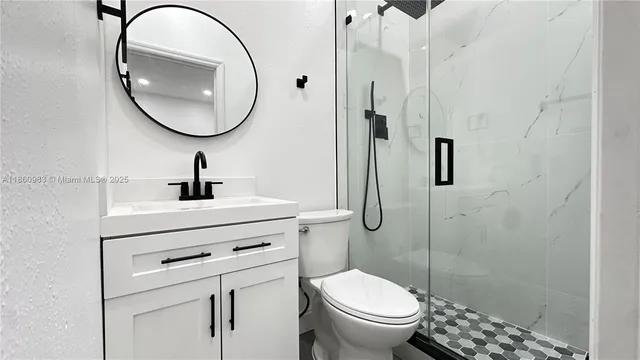 a bathroom with a sink a toilet and a mirror