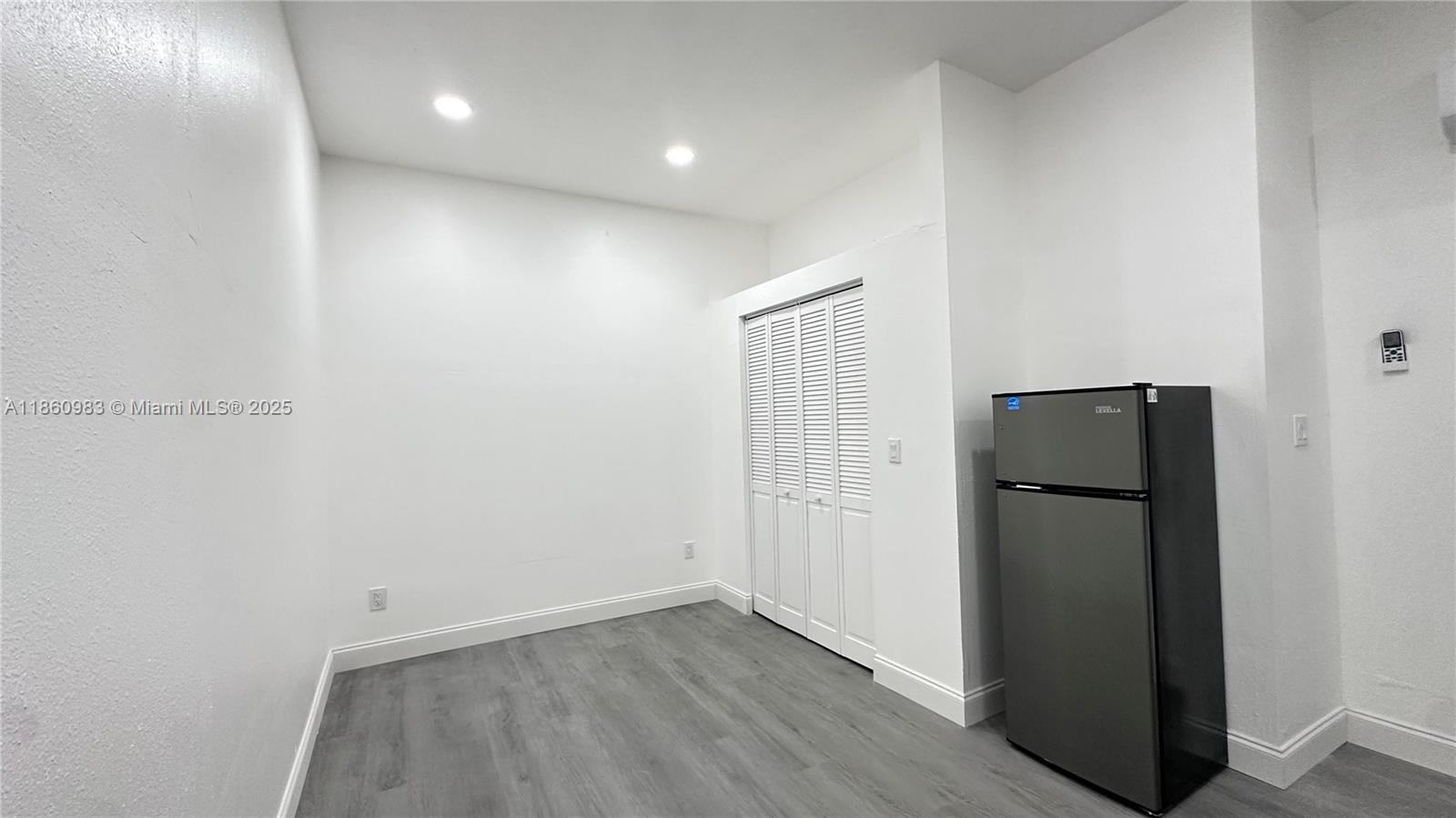 12983 Southwest 229th Lane Miami, FL 33170 - Photo 7 of 9 an empty room with wooden floor