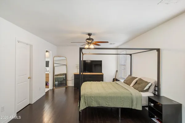 a bedroom with a bed and wooden floor
