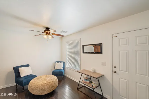 a bedroom with furniture and wooden floor