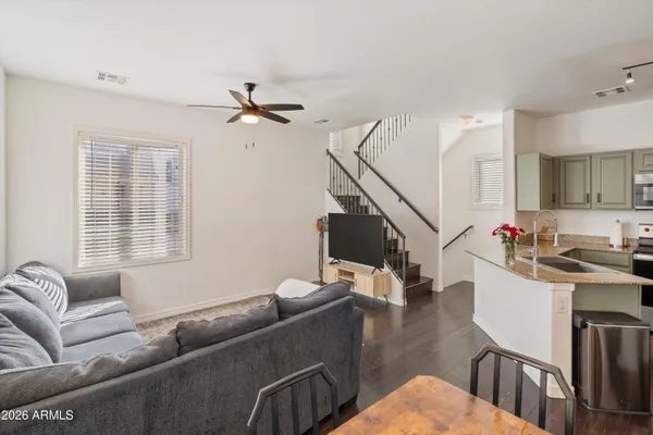 a living room with furniture flat screen tv and a window