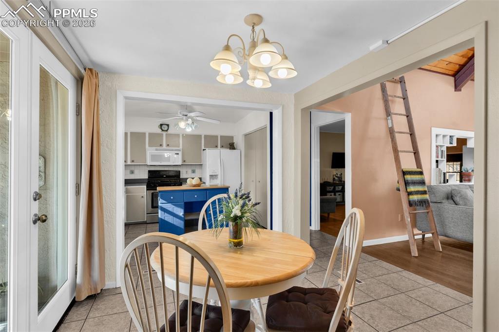 5796 County Rd CC108 Colorado City, CO 81019 - Photo 16 of 48 a view of a dining room with furniture and a chandelier