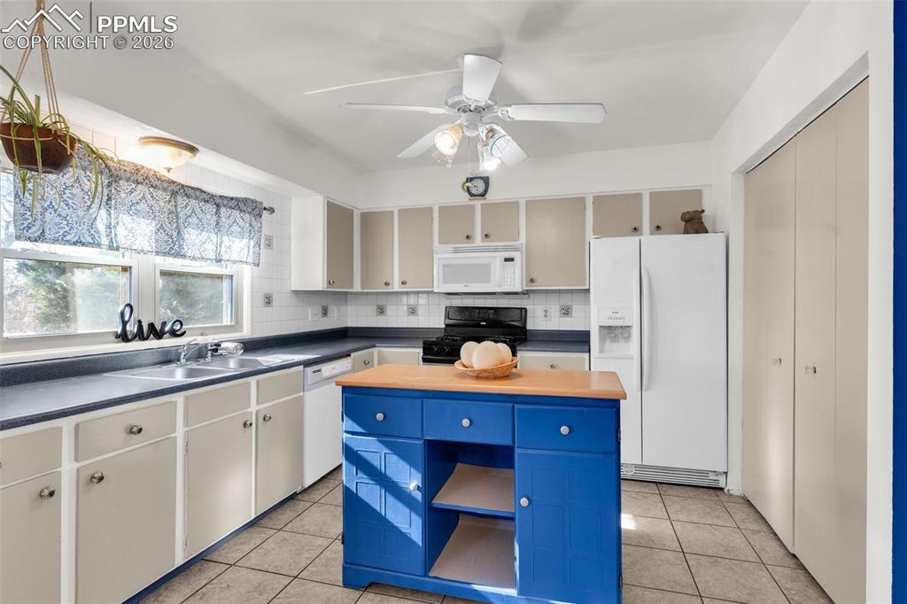 5796 County Rd CC108 Colorado City, CO 81019 - Photo 18 of 48 a kitchen with white cabinets and refrigerator
