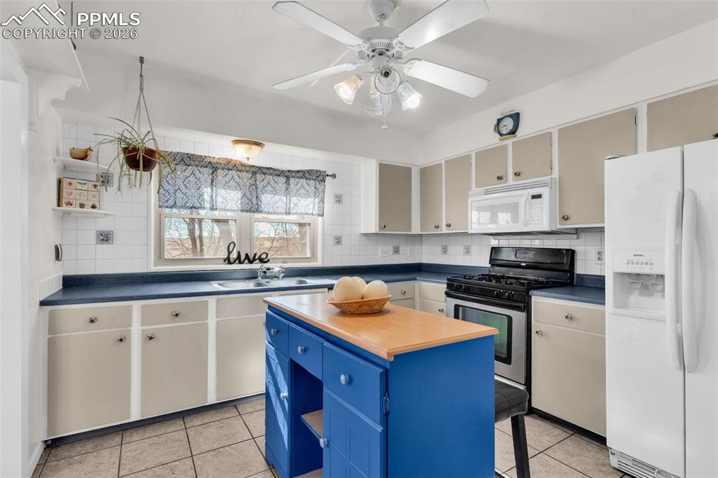 5796 County Rd CC108 Colorado City, CO 81019 - Photo 19 of 48 a kitchen with a sink a stove and cabinets