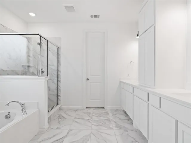 a white bath tub sitting next to a shower