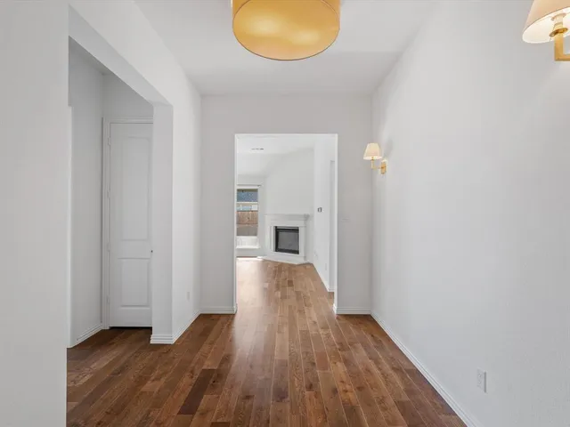 a view of a room with wooden floor and lamp