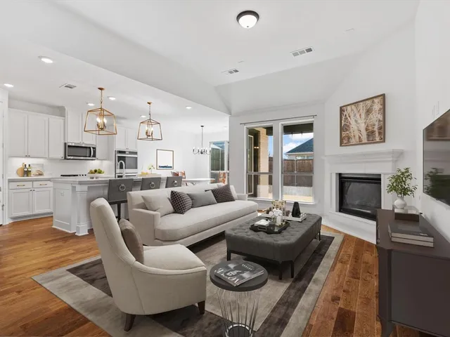 a living room with furniture fireplace and a table
