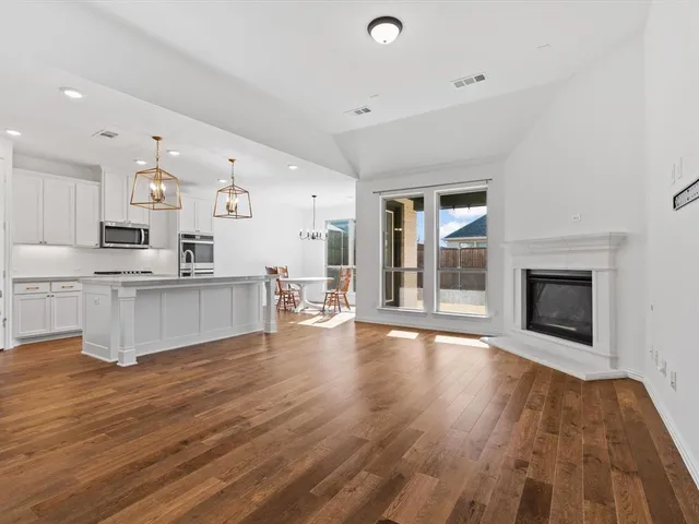 a view of kitchen with cabinets and wooden floor