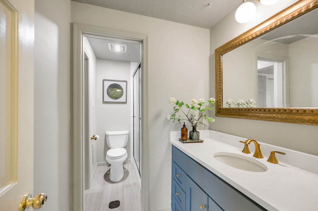 43 Constitution Way, Unit 43 Methuen, MA 01844 - Photo 17 of 25 a bathroom with a granite countertop sink and a mirror