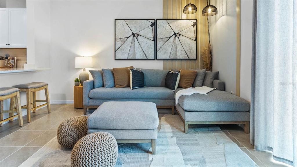 4366 Butterscotch Circle Lakeland, FL 33811 - Photo 16 of 30 a living room with furniture and a wall painting