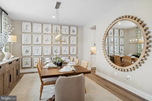 a view of a dining room with furniture and chandelier