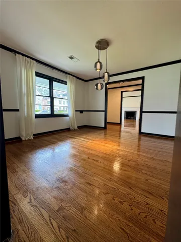 a view of a livingroom with wooden floor and a ceiling fan