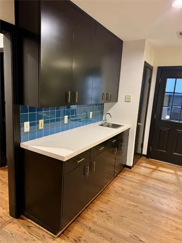 a kitchen with a sink a counter top space and cabinets