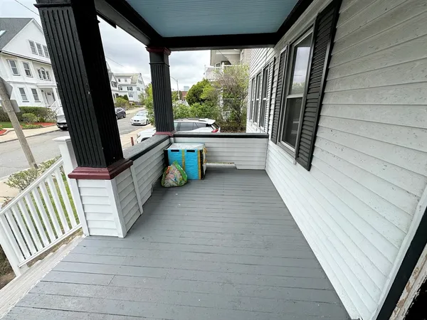 a view of a porch with wooden floor and furniture