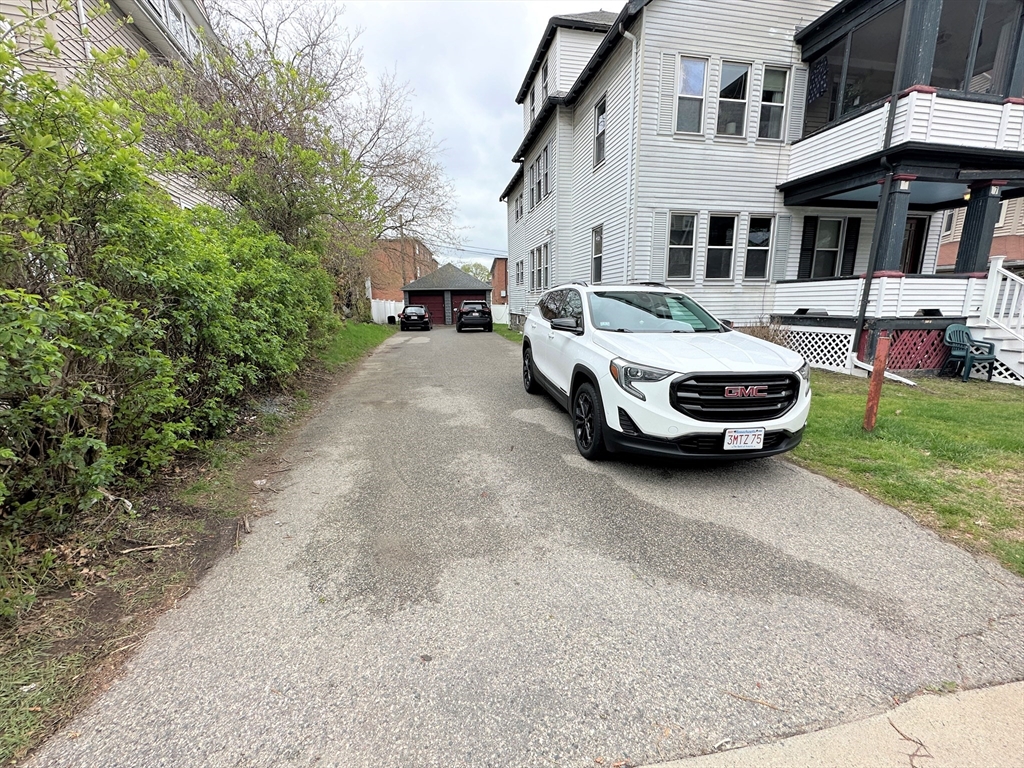 17 Bentley Street, Unit 1 Boston, MA 02135 - Photo 14 of 15 a car parked in front of a white house
