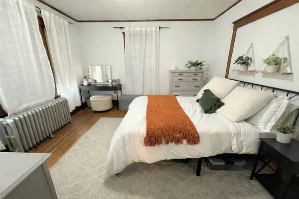 a bedroom with a bed and a mirror