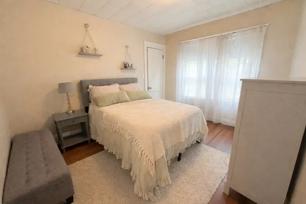 a bed room with a bed and a window