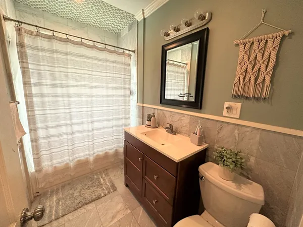 a bathroom with a double vanity sink mirror and toilet
