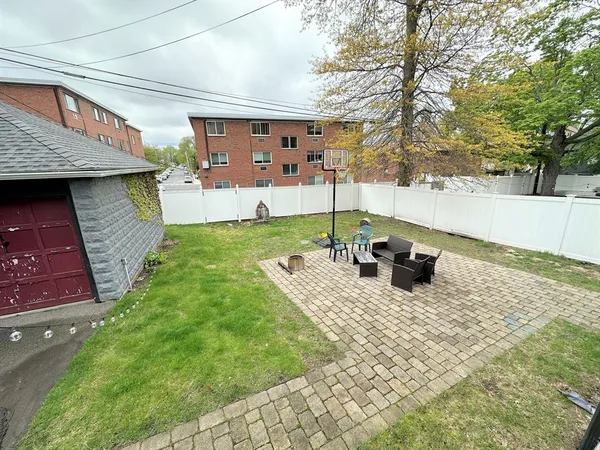 a view of a backyard with table and chairs