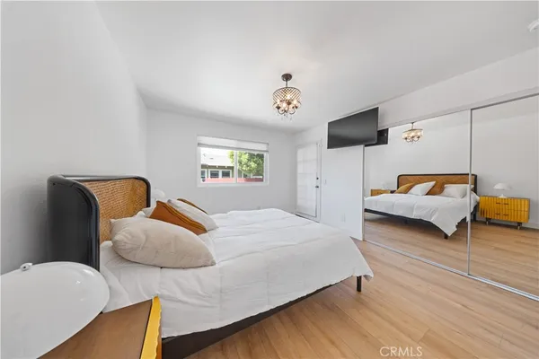 a bedroom with two beds and a chandelier