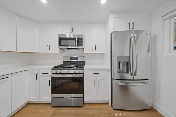 a kitchen with a refrigerator sink and stove