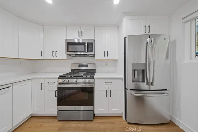 a kitchen with a refrigerator sink and stove