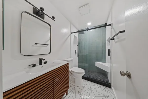 a bathroom with a sink toilet and shower