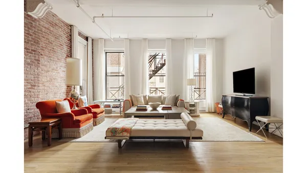 a living room with furniture wooden floor and a flat screen tv