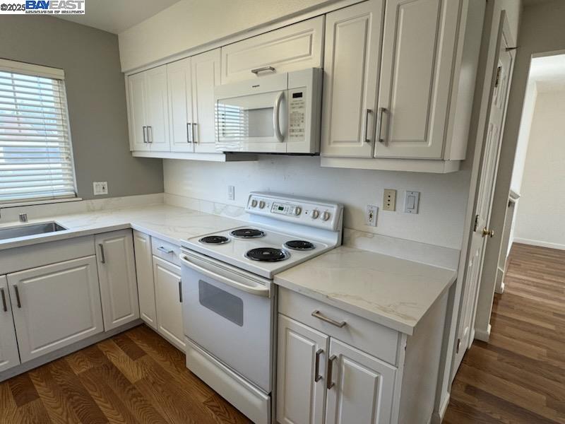211 Maple Street Livermore, CA 94550 - Photo 5 of 11 a kitchen with stainless steel appliances granite countertop a sink and dishwasher a stove top oven with white cabinets