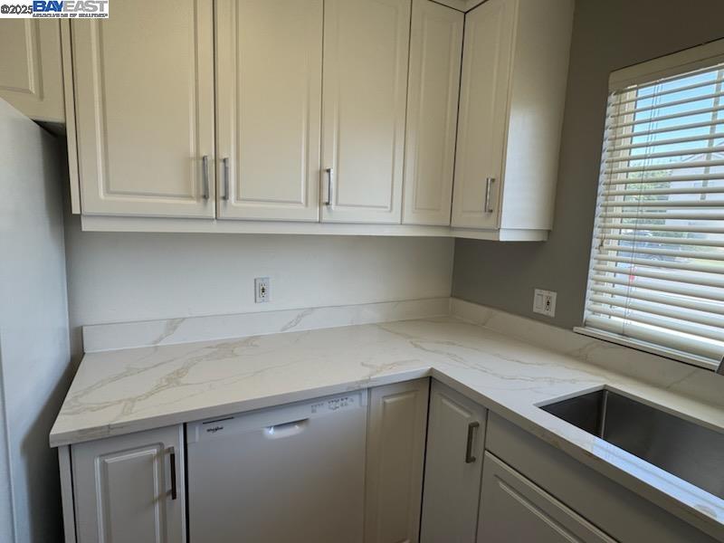 211 Maple Street Livermore, CA 94550 - Photo 6 of 11 a kitchen with granite countertop white cabinets and a sink