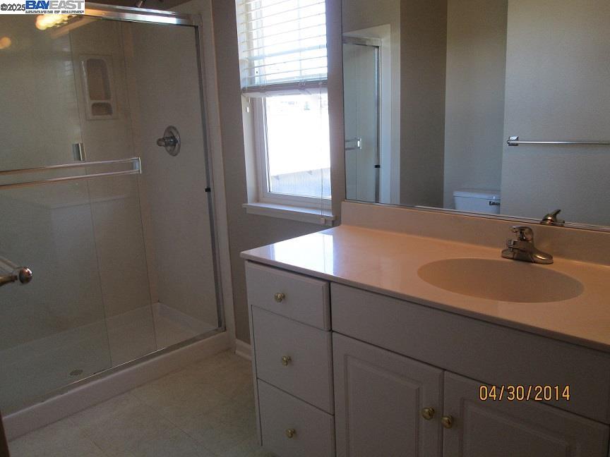 211 Maple Street Livermore, CA 94550 - Photo 10 of 11 a bathroom with a sink and a mirror