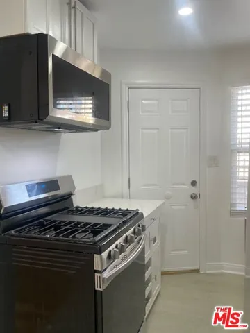 a kitchen with a stove and a microwave