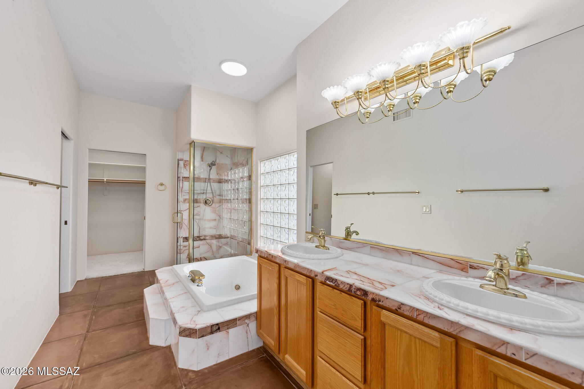3655 North Harrison Road Tucson, AZ 85749 - Photo 25 of 51 a bathroom with a sink double vanity granite tub shower and a mirror