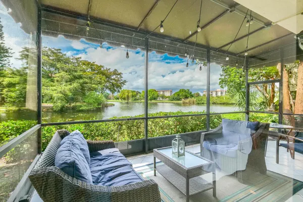 a view of a porch with furniture and a yard